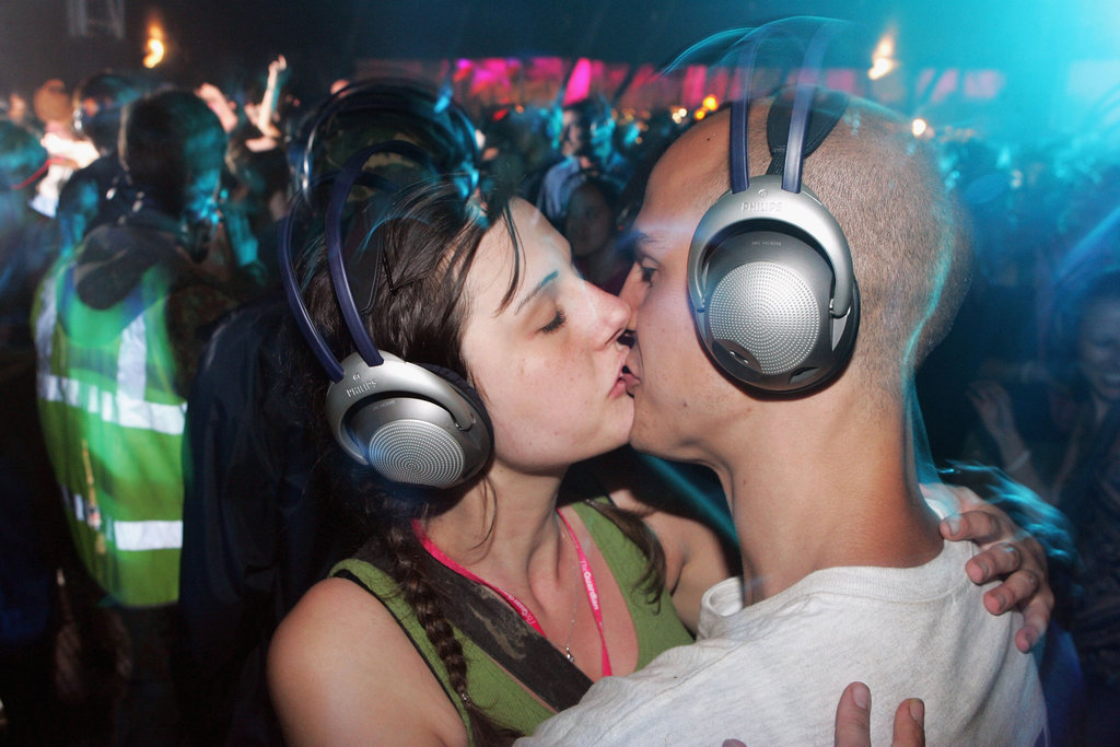 A couple in headphones smooched at the Glastonbury Music Festival in England.
A couple in headphones smooched at the Glastonbury Music Festival in England.
