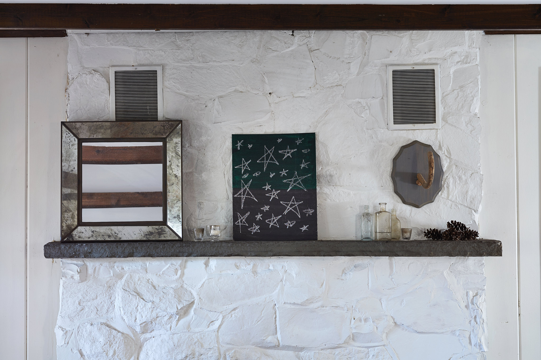 White paint gives the retro fireplace facade a fresh