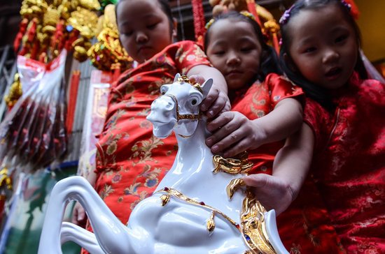 Kids held on to a horse figurine, which symbolized the Year of the Horse, in the Philippines. Kids held on to a horse figurine, which symbolized the Year of the Horse, in the Philippines.