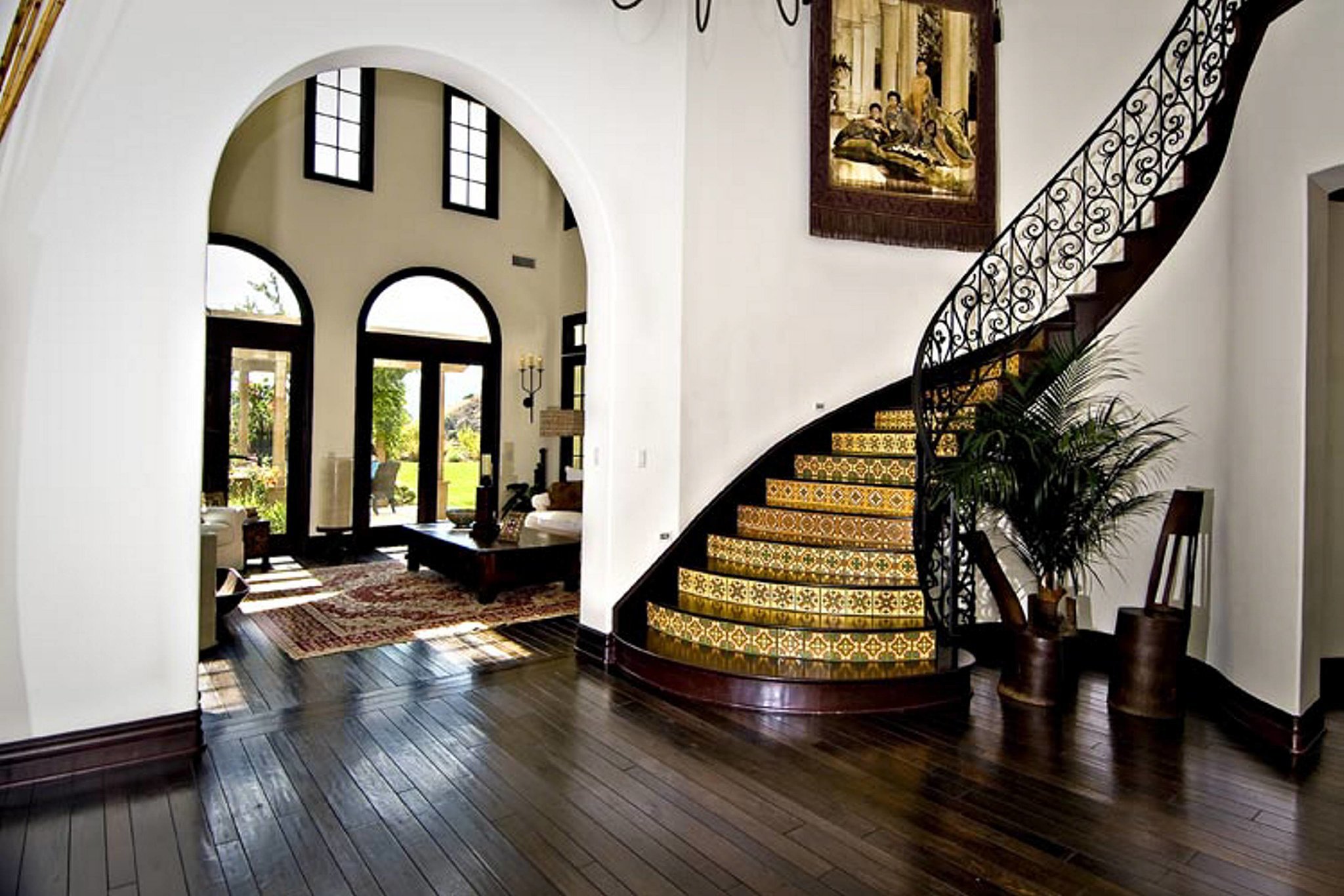 A curved staircase leading upstairs makes for a stunning entryway
