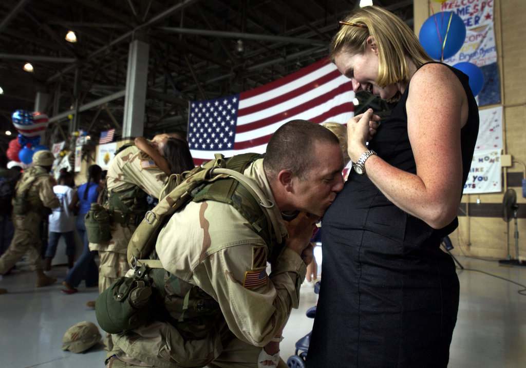 Capt. Tory Burgess of the U.S. Army's 4th Brigade kissed his wife Kathleen's belly on July 16, 2003, at Hunter Army Airfield in Savannah, GA, after returning home from Iraq.
Capt. Tory Burgess of the U.S. Army's 4th Brigade kissed his wife Kathleen's belly on July 16, 2003, at Hunter Army Airfield in Savannah, GA, after returning home from Iraq.